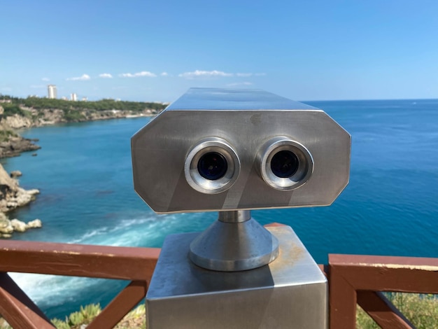 Blue binoculars on the observation deck on the background