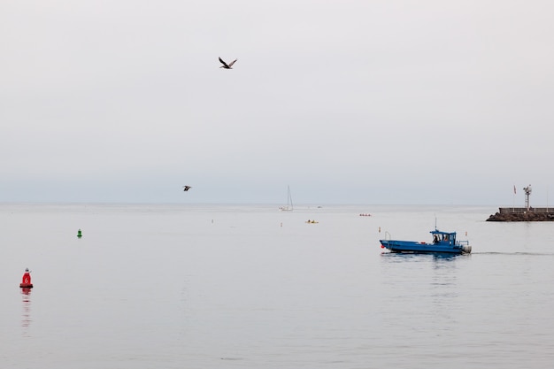 Blue boat slipping out of Santa Barbara harbour