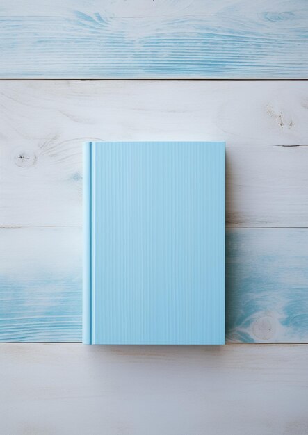 A blue book on a wooden table with a blue cover