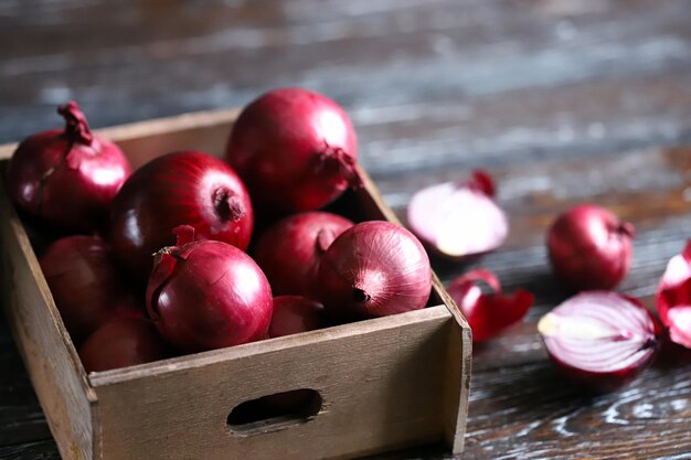 Blue bow in a wooden box Cut red onion