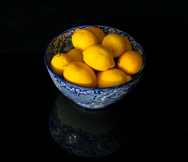 A blue bowel filled with ripe lemons