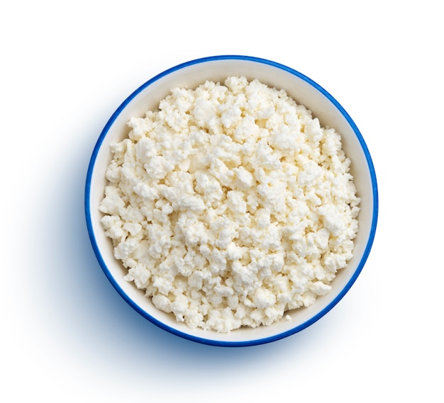 Blue bowl of cottage cheese isolated on white with clipping path, top view