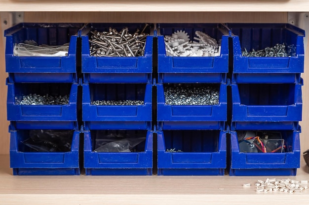 Premium Photo  Blue box with small construction objects many storage  compartments are filled with construction supplies containing screws nuts bolts  nails and other workshop tools