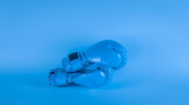 blue boxing gloves on a blue background