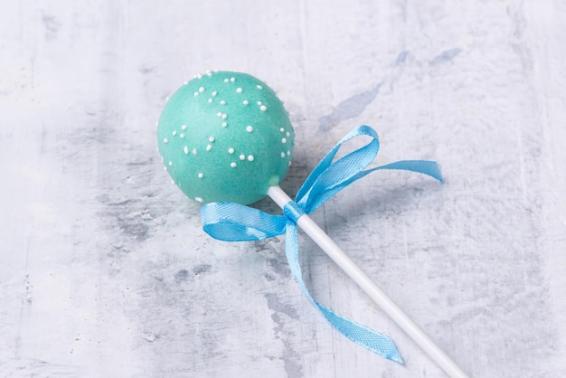 Blue cake pop on a textured background