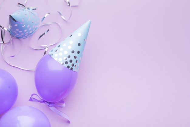blue caps, purple balls and silver serpentine on a purple paper background. holiday background.