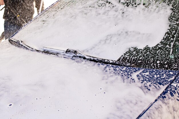 Blue car in foam at a car wash