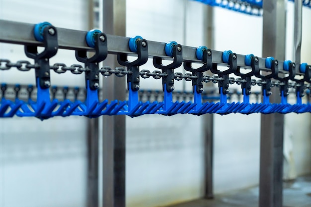 A blue chain is being used to move the chain into a machine.