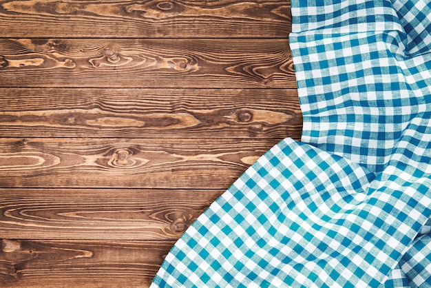 Blue checkered tablecloth on wooden table