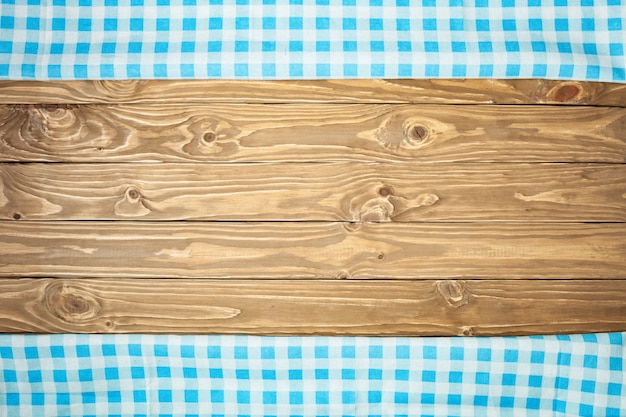 Blue checkered tablecloth on wooden table