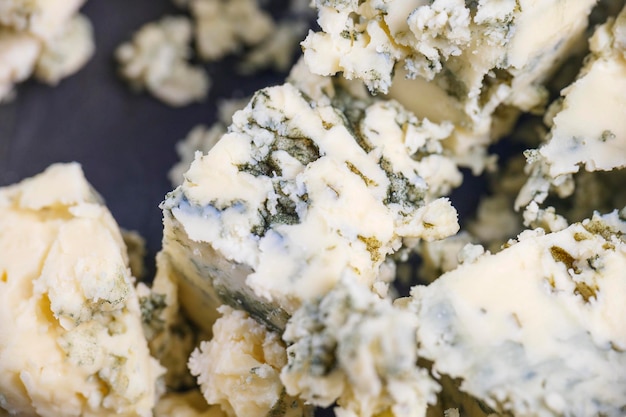 Blue cheese diced close-up. food cheese.