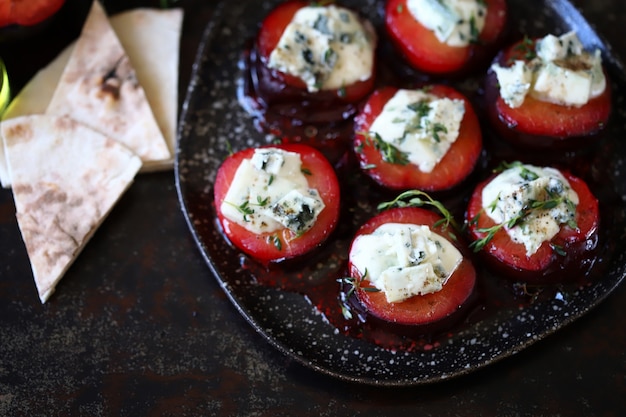 Blue cheese and thyme in baked plums