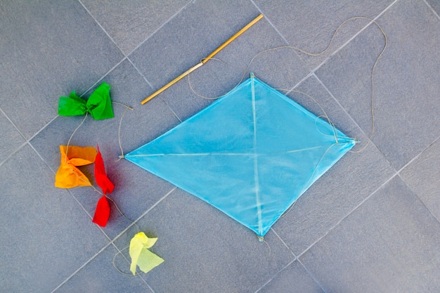 blue children kite traditional diamond shape on floor