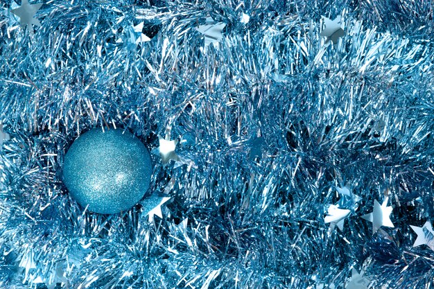 Blue christmas balls on blue tinsel. New year texture. New Year 2019. Toys