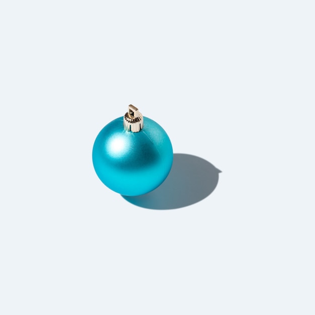 Blue Christmas bauble with strong shadows