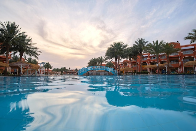 Blue clear water with small ripple waves in swimming pool at tropical resort Summer vacations concept