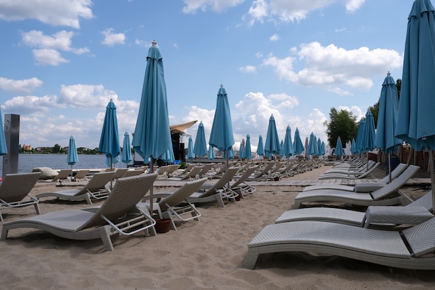 Blue closed stationary beach umbrellas