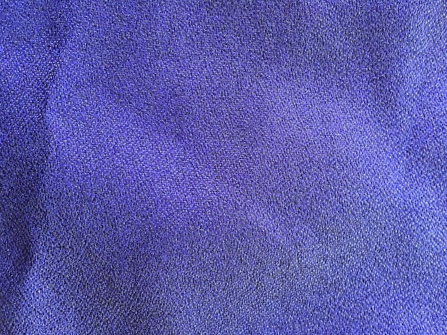 Blue cloth surface with wrinkles and details of the fabric visible