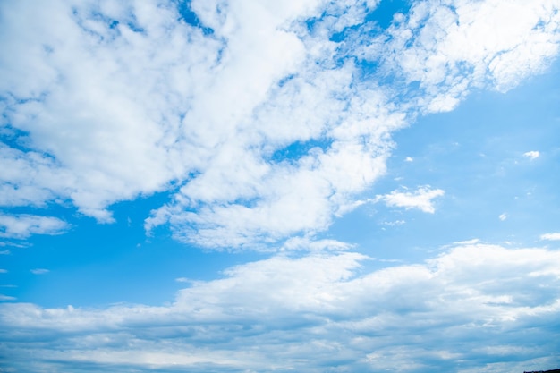 Blue cloudscape background with white fluffy clouds