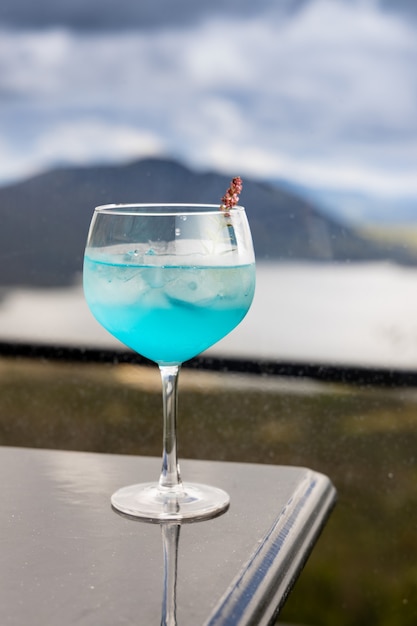 Blue cocktail on top of black table