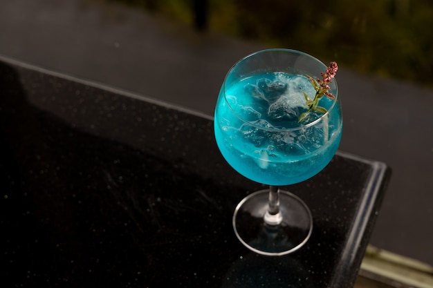 Blue cocktail on top of black table