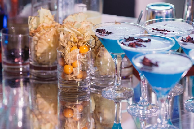 Blue cocktails on a buffet table before a party