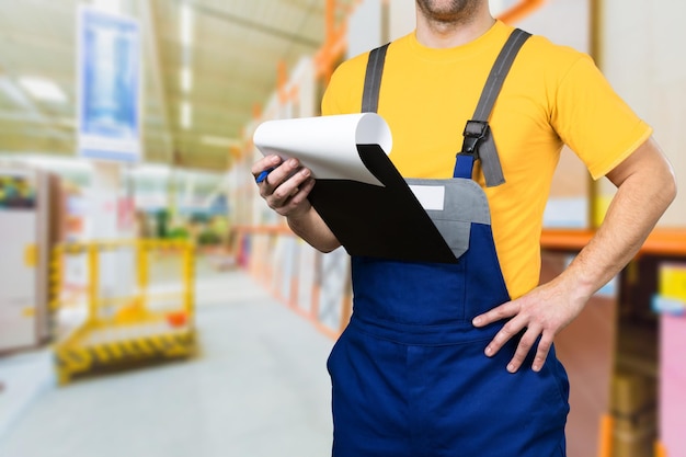 Blue collar worker. Man holding clipboard