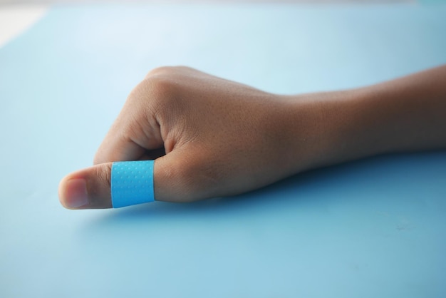 Blue color adhesive bandage on hand