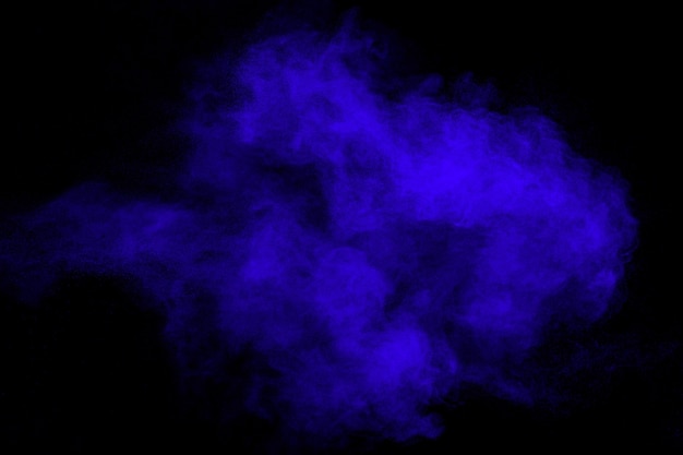 Blue color dust particles splash on black background.