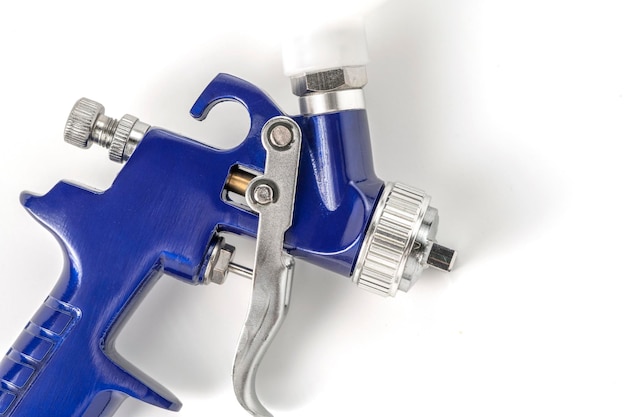 Blue color paint gun on a white background closeup