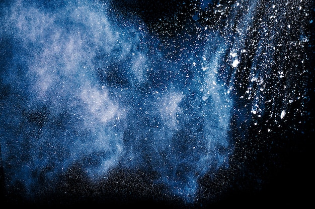 Photo ิblue color powder explosion on black background.