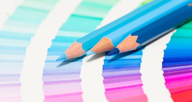 Blue colored pencils and color chart of all colors