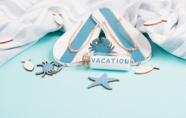 Photo blue colored summer and holiday background, flippers, sea stars and a glass bootle vacation