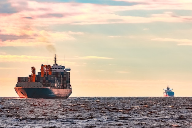 Photo blue container ship, world logistics and production transfer