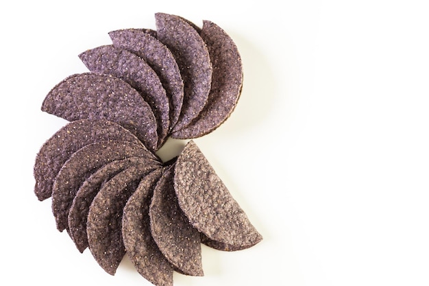 Blue corn taco shells on a white background.