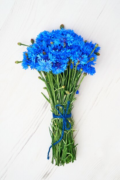 Blue Cornflower bouquet on white wooden. 