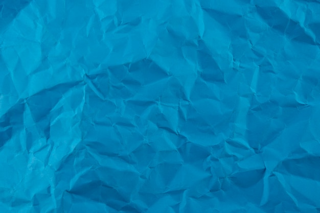 Синий мятый фон текстуры бумаги
