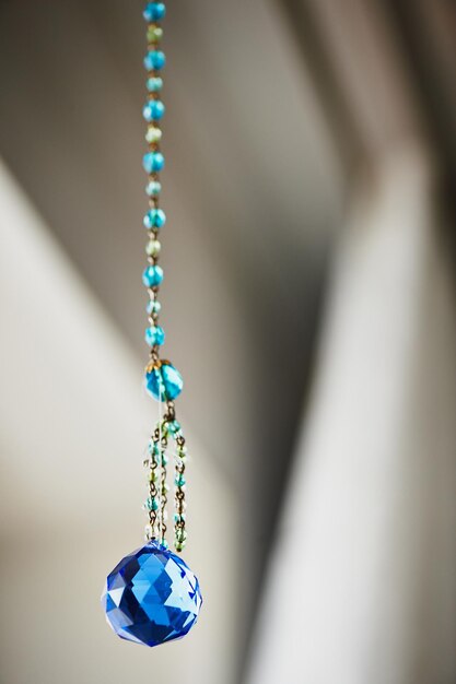 Blue crystal Feng Shui hanging on a string of beads