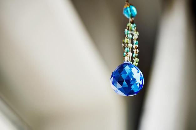 Blue crystal Feng Shui hanging on a string of beads