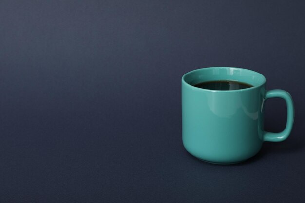 blue cup on dark blue background space for text