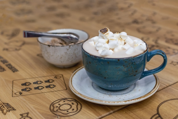 Blue cup with cocoa and marshmallows