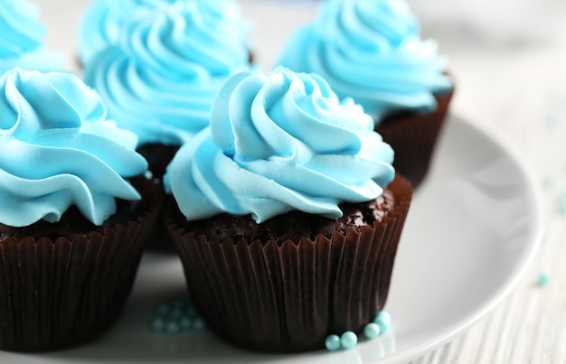 Blue cupcakes on wooden table