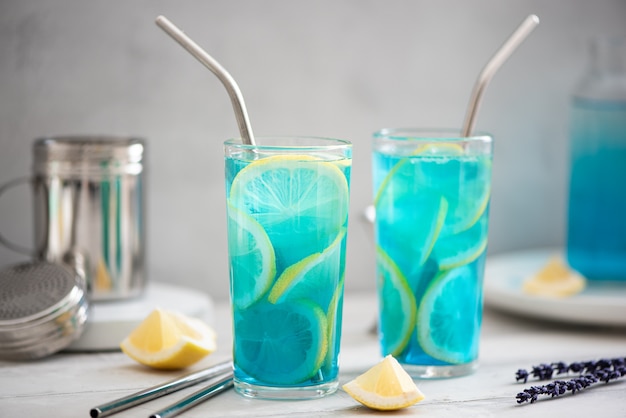 Blue curacao cocktail with lemon slices in tall glasses