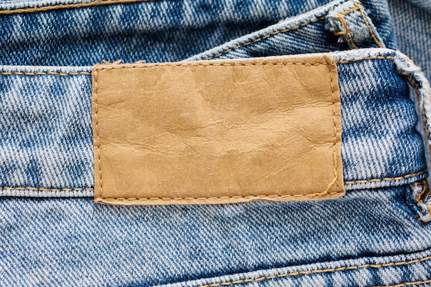 Priorità bassa di struttura dell'etichetta in pelle jeans denim blu