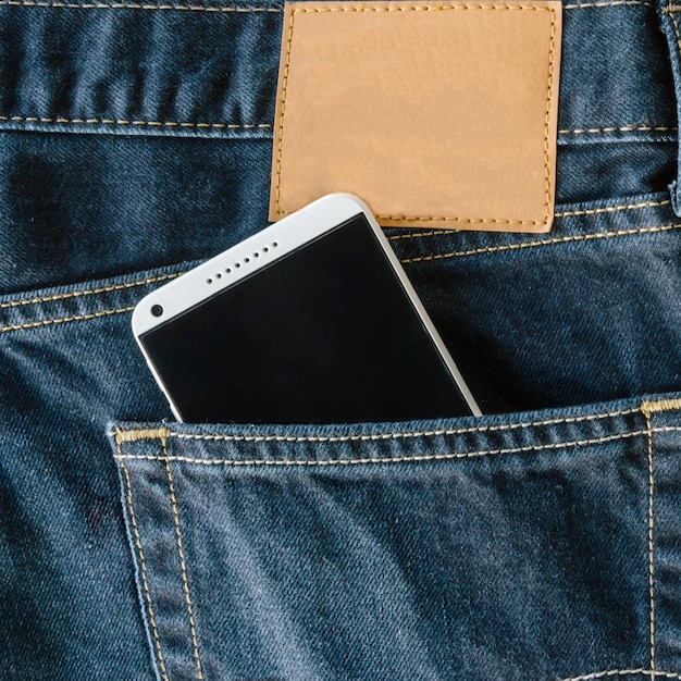 Premium Photo | Blue denim jeans pocket with mobile phone.