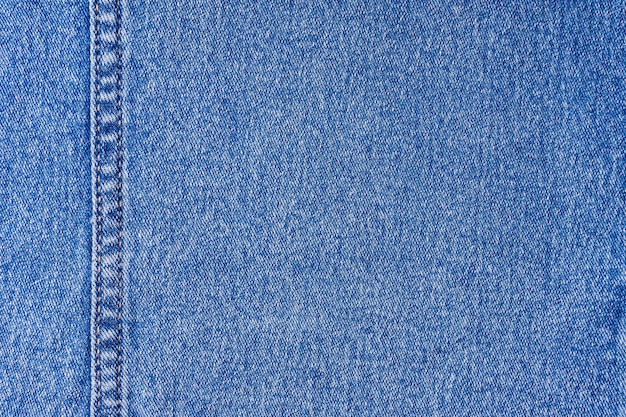 Photo blue denim jeans with a seam texture background