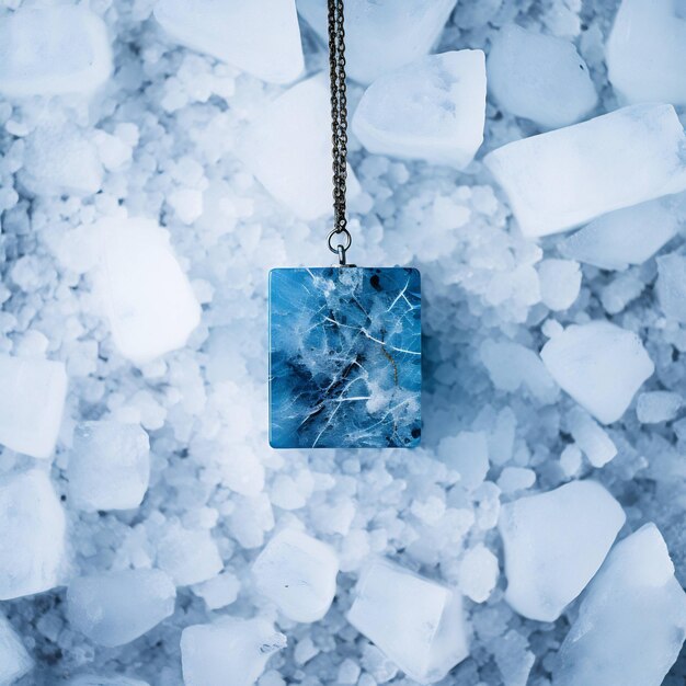 a blue diamond necklace hangs from a chain