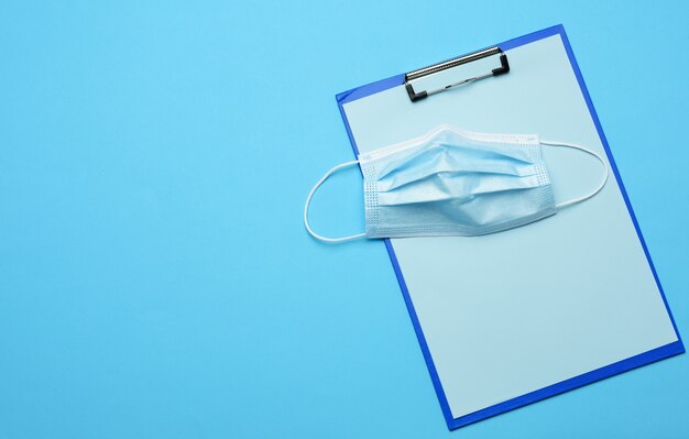 Blue disposable medical mask on blue