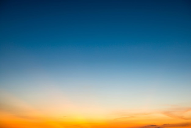 Blue dramatic sunset sky with golden rays of sun light. Can be used as nature background