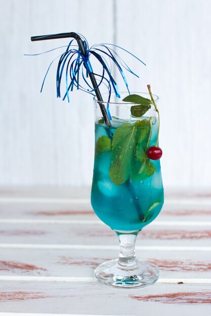 Blue drink with mint and cherry ice. 